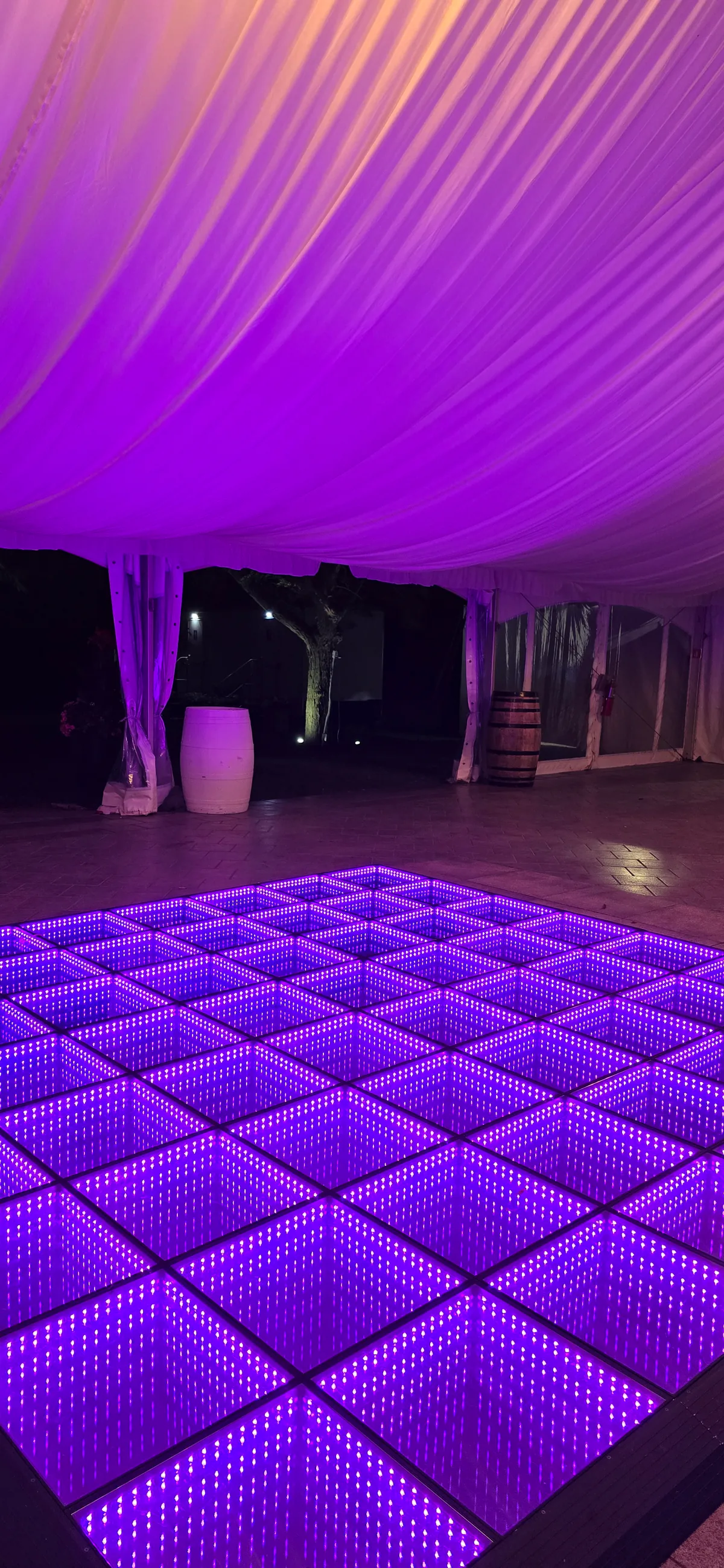 Purple infinity LED floor inside a draped tent