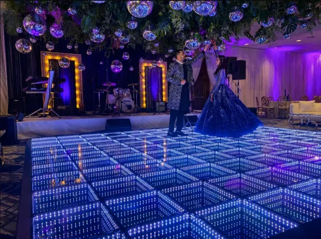 Couple sharing a first dance on an infinity LED dance floor