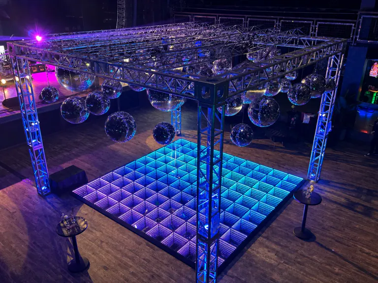 Infinity LED dance floor installed beneath event lighting and rigging
