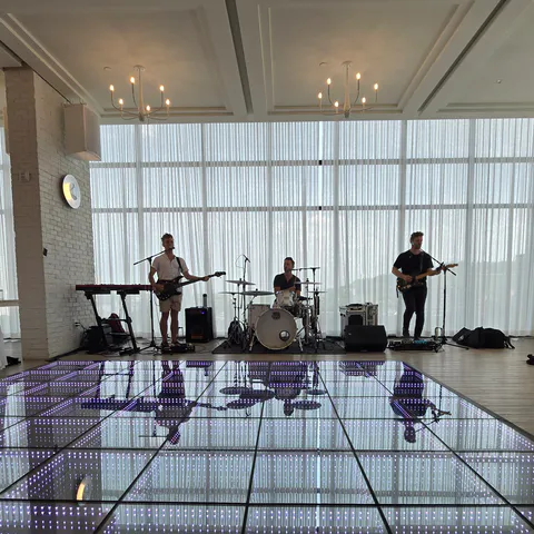 Live band performing beyond an infinity LED dance floor