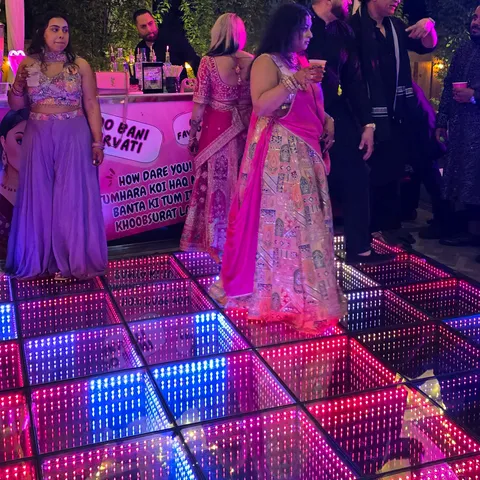 Guests gathered around a colorful infinity LED dance floor