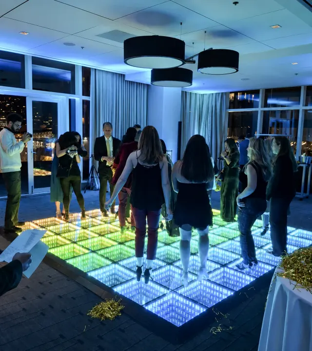 Guests celebrating on a colorful infinity LED dance floor